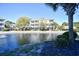 Beautiful water view featuring a pond and community buildings, offering a serene setting at 6253 Catalina Dr. # 214, North Myrtle Beach, SC 29582