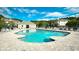Community swimming pool surrounded by lounge chairs, umbrellas, and beautiful landscaping at 6253 Catalina Dr. # 214, North Myrtle Beach, SC 29582