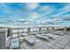 Rooftop deck overlooking the ocean, with lounge chairs and tables at 6253 Catalina Dr. # 214, North Myrtle Beach, SC 29582