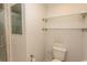 Bathroom with glass shower, toilet, and glass shelving at 7638 Highway 905, Longs, SC 29568