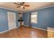 Bedroom features wood floors, built-in shelving, and a ceiling fan at 7638 Highway 905, Longs, SC 29568