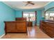 Charming bedroom with turquoise walls, wood flooring, and vintage wooden furniture at 7638 Highway 905, Longs, SC 29568