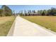 Long driveway leads up to brick home with large manicured yard at 7638 Highway 905, Longs, SC 29568