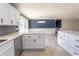 Modern kitchen with white cabinets, stainless steel appliances, and view into the dining room at 7638 Highway 905, Longs, SC 29568