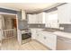 Corner kitchen with white cabinets, stainless steel appliances, and modern backsplash at 7638 Highway 905, Longs, SC 29568