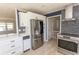 Updated kitchen with stainless steel appliances, white cabinetry, and mosaic backsplash at 7638 Highway 905, Longs, SC 29568