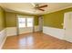 Living room with wainscoting, green walls, wood flooring, and natural light from the windows at 7638 Highway 905, Longs, SC 29568