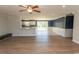 Open-concept living room with hardwood floors, a ceiling fan, and sliding doors to the backyard at 7638 Highway 905, Longs, SC 29568