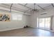 Bright, open living room featuring hardwood floors, white walls and a sliding glass door at 7638 Highway 905, Longs, SC 29568