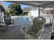Relaxing back porch with wicker rocking chair, looking out to a fenced pool area at 806 Duncan Ave., Myrtle Beach, SC 29572