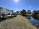Picturesque view of a pond with a house in the background, providing a serene and private outdoor space at 806 Duncan Ave., Myrtle Beach, SC 29572