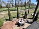 Elevated patio with an outdoor dining table offering peaceful views of the landscaped backyard and trees at 817 Falkirk St., Myrtle Beach, SC 29579
