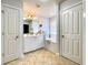 Bathroom with double vanity sink, bathtub, white cabinets and tile flooring at 817 Falkirk St., Myrtle Beach, SC 29579