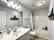 Bright bathroom featuring vanity, toilet, bathtub with shower, and storage shelves at 817 Falkirk St., Myrtle Beach, SC 29579