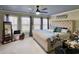Bright bedroom featuring upholstered bed, ceiling fan, and three large windows at 817 Falkirk St., Myrtle Beach, SC 29579