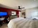 Primary bedroom features a red accent wall, dresser with mirror, ceiling fan, and closet doors at 817 Falkirk St., Myrtle Beach, SC 29579