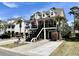 Charming two-story home with a fountain, double garages, and a covered porch adorned with American flags at 817 Falkirk St., Myrtle Beach, SC 29579