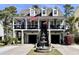 Charming two-story home with a fountain, double garages, and a covered porch adorned with American flags at 817 Falkirk St., Myrtle Beach, SC 29579