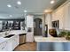 Bright kitchen has white cabinets, marble countertops, stainless steel appliances, and tile flooring at 817 Falkirk St., Myrtle Beach, SC 29579