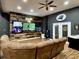 Game room featuring a sectional sofa, mounted TVs, wood accent wall and ceiling fan at 817 Falkirk St., Myrtle Beach, SC 29579