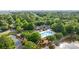 Stunning aerial view showcasing a community pool and clubhouse enveloped by lush landscaping and serene ponds at 820 Morrall Dr., North Myrtle Beach, SC 29582