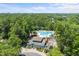 Aerial view of a large community pool with chairs, set amongst a forest of lush green trees at 820 Morrall Dr., North Myrtle Beach, SC 29582