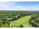 Expansive golf course aerial view showcasing verdant fairways, serene ponds, and lush tree-lined neighborhoods at 820 Morrall Dr., North Myrtle Beach, SC 29582