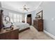 Bedroom with blue walls, plantation shutters, and wood furniture at 820 Morrall Dr., North Myrtle Beach, SC 29582