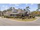 Beautifully landscaped corner lot featuring a well-maintained home with brick and siding exterior at 820 Morrall Dr., North Myrtle Beach, SC 29582
