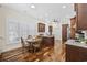 Eat-in kitchen features warm wood floors, granite counters, and plantation shutters at 820 Morrall Dr., North Myrtle Beach, SC 29582