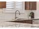 Close-up of the kitchen sink featuring granite countertops and white subway tile at 820 Morrall Dr., North Myrtle Beach, SC 29582