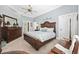 Spacious main bedroom features a wooden bed frame, ceiling fan, and neutral-toned walls at 820 Morrall Dr., North Myrtle Beach, SC 29582