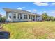 Charming backyard featuring a well-manicured lawn and covered patio at 8504 Juxa Dr., Myrtle Beach, SC 29579
