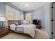 Inviting bedroom with a comfortable bed, soft carpet, and natural light from large windows at 8504 Juxa Dr., Myrtle Beach, SC 29579