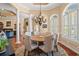 Bright dining room featuring a decorative chandelier, hardwood floors, and an arched entryway at 8504 Juxa Dr., Myrtle Beach, SC 29579