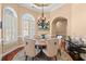 Cozy dining area featuring an ornate chandelier, hardwood floors, and comfortable seating for six at 8504 Juxa Dr., Myrtle Beach, SC 29579