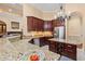 Spacious kitchen featuring granite countertops, stainless steel appliances, island with wine rack, and dark wood cabinets at 8504 Juxa Dr., Myrtle Beach, SC 29579