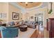 Spacious living room with hardwood floors, a ceiling fan, and comfortable leather seating at 8504 Juxa Dr., Myrtle Beach, SC 29579