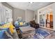 Comfortable living room with a large window, sliding glass doors, blue sofa, and a decorative rug at 8504 Juxa Dr., Myrtle Beach, SC 29579