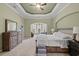 Spacious main bedroom with tray ceiling, large bed, dresser, and sitting area with a view at 8504 Juxa Dr., Myrtle Beach, SC 29579