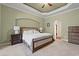 Inviting main bedroom featuring a large bed, bedside tables, dresser, and an arched doorway at 8504 Juxa Dr., Myrtle Beach, SC 29579