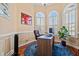Home office features hardwood floors, arched windows with plantation shutters, and a wooden desk with a computer at 8504 Juxa Dr., Myrtle Beach, SC 29579