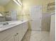 Bathroom featuring dual sinks, modern fixtures, and tiled flooring at 86 Old Barge Dr., Pawleys Island, SC 29585