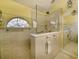 Bathroom with glass enclosed shower, tiled walls, and bright window at 86 Old Barge Dr., Pawleys Island, SC 29585