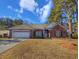 Charming brick home featuring a well-manicured lawn, two-car garage, and a welcoming entrance at 86 Old Barge Dr., Pawleys Island, SC 29585
