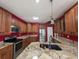 Spacious kitchen features stainless steel appliances, granite countertops, and warm wood cabinetry at 86 Old Barge Dr., Pawleys Island, SC 29585