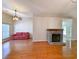 An expansive living area with hardwood floors, ceiling fan, stone fireplace, and natural light at 86 Old Barge Dr., Pawleys Island, SC 29585