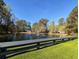View of a community pond with a fountain, surrounded by green grass and trees at 86 Old Barge Dr., Pawleys Island, SC 29585