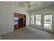 Cozy sunroom featuring many windows, neutral carpet, and an entrance to the living room at 86 Old Barge Dr., Pawleys Island, SC 29585