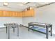 Finished garage with built in cabinets and entertainment options like foosball and air hockey tables at 9648 Bradford Ln., Murrells Inlet, SC 29576